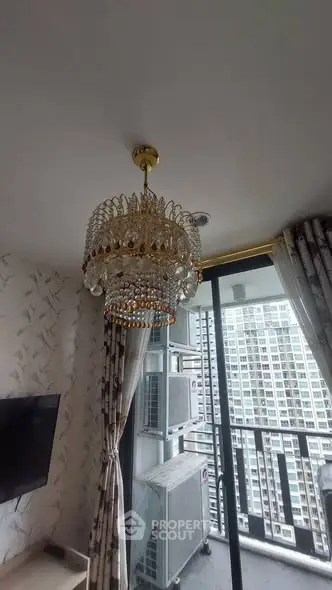 Luxurious living room with elegant chandelier and city view balcony