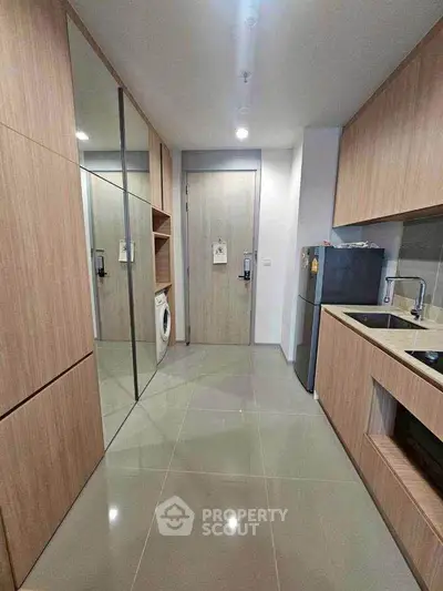 Modern kitchen with sleek wooden cabinetry and integrated appliances