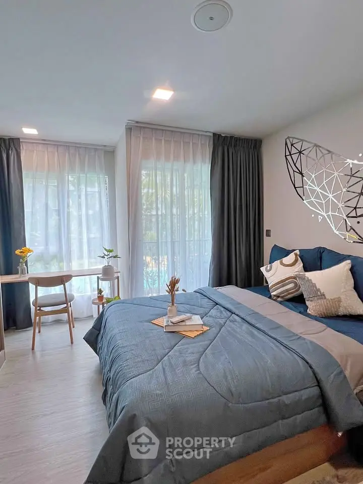 Modern bedroom with stylish decor and large windows offering natural light