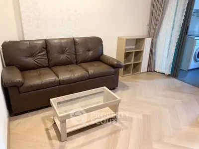 Cozy living room with brown leather sofa and modern wooden coffee table.