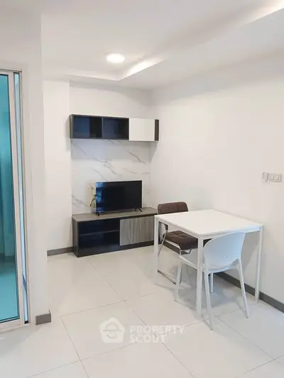 Modern living room with sleek furniture and TV, perfect for cozy relaxation.