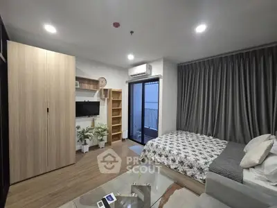 Modern bedroom with balcony access, featuring sleek furniture and stylish decor.