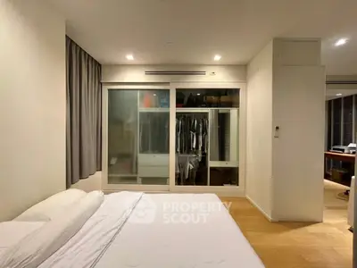 Modern bedroom with built-in closet and cozy lighting