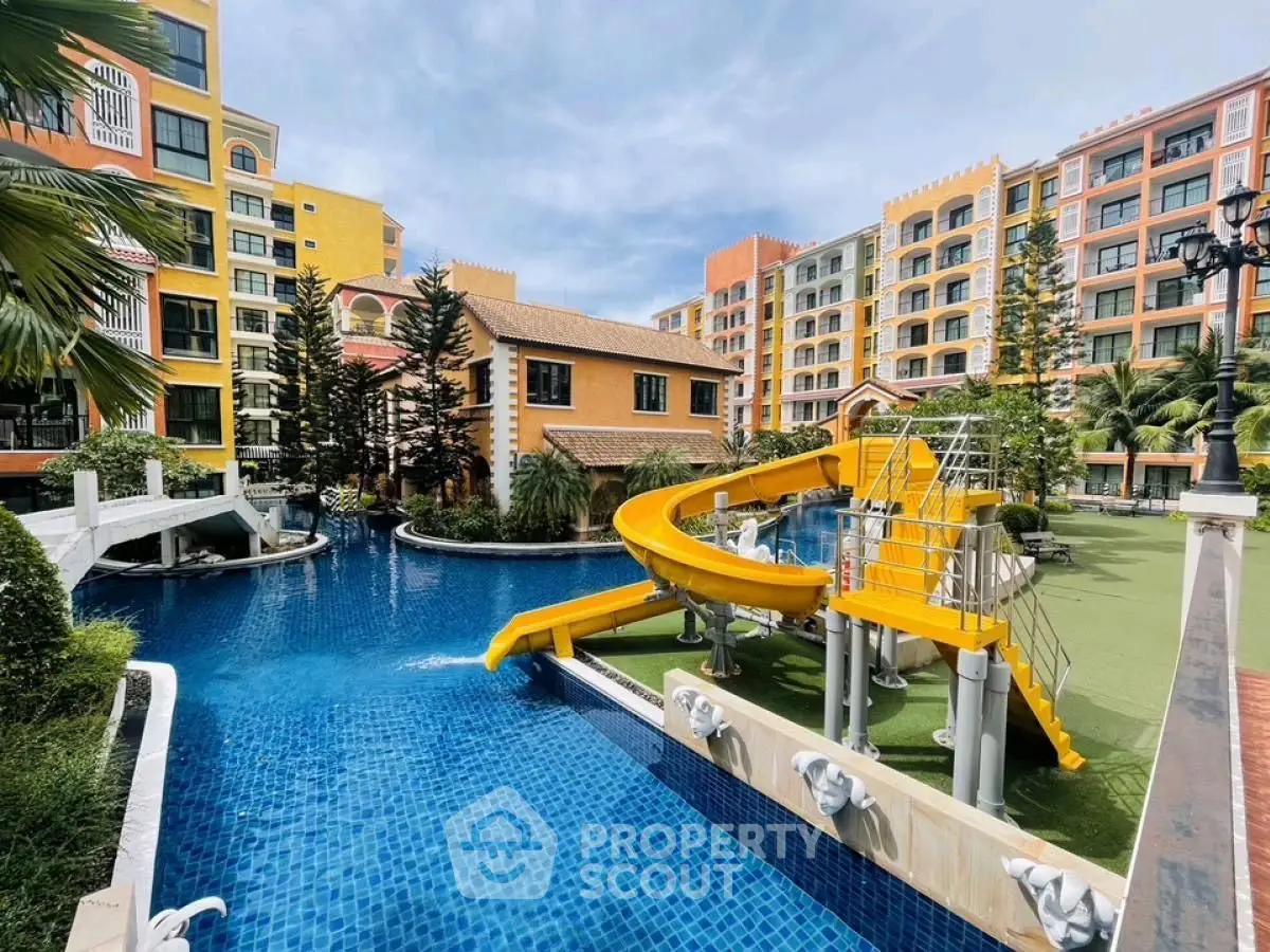 Luxurious apartment complex with vibrant architecture and inviting pool with slide.