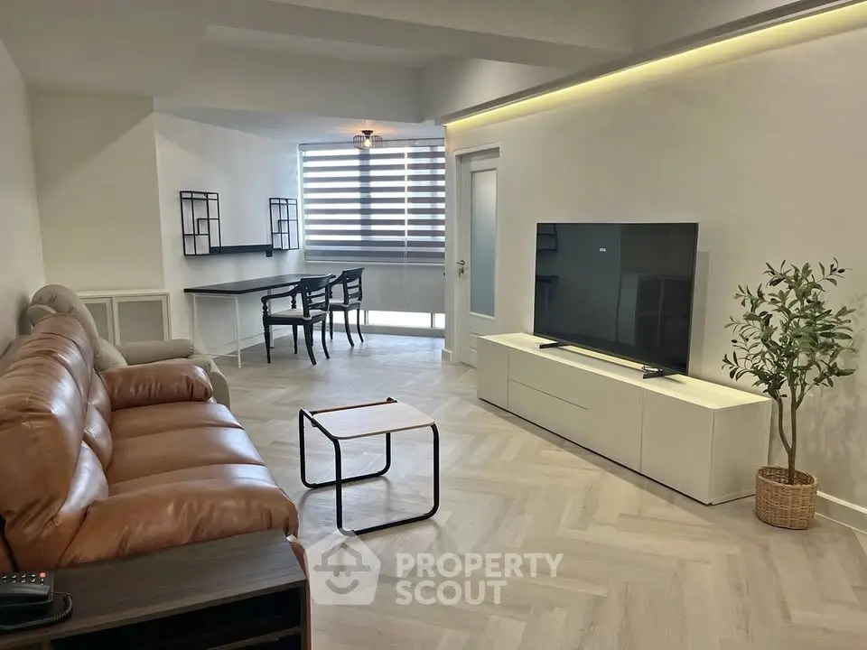 Modern living room with stylish furniture and large TV, perfect for relaxation and entertainment.