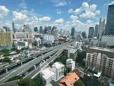 Stunning cityscape view from high-rise building showcasing urban skyline and bustling highway.