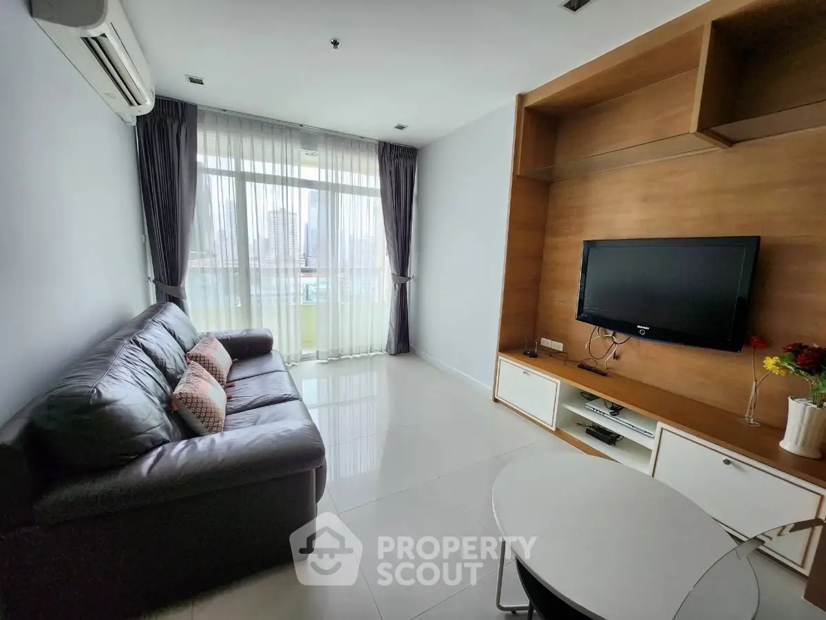 Modern living room with sleek furniture and city view, perfect for urban living.