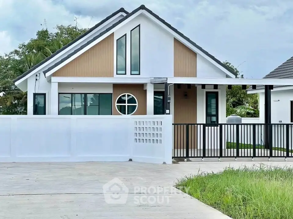 Modern single-story house with unique circular window and sleek design