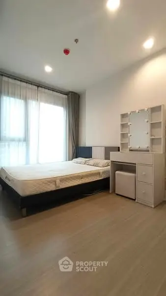 Spacious bedroom with modern decor and natural light