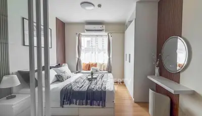 Modern bedroom with stylish decor and ample natural light, featuring a cozy bed and sleek storage solutions.