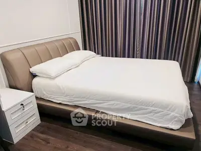 Modern bedroom with elegant bed and stylish curtains in a cozy apartment.