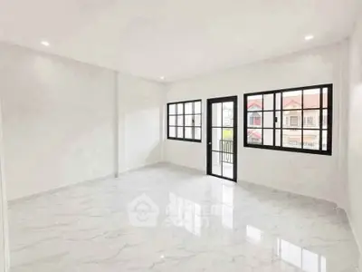 Spacious modern living room with large windows and marble flooring