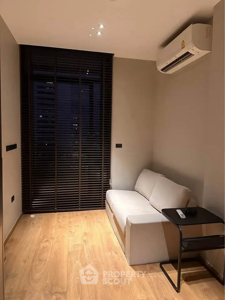 Cozy modern living room with sleek wooden flooring and air conditioning