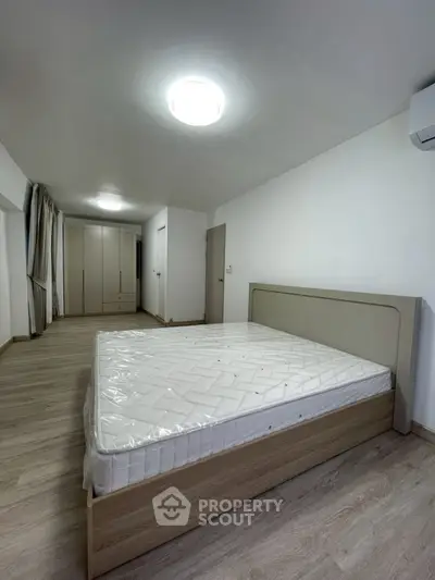 Spacious bedroom with modern design and ample storage space