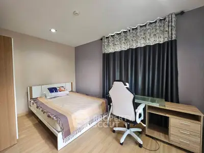 Modern bedroom with stylish decor and workspace, featuring a comfortable bed and sleek desk.