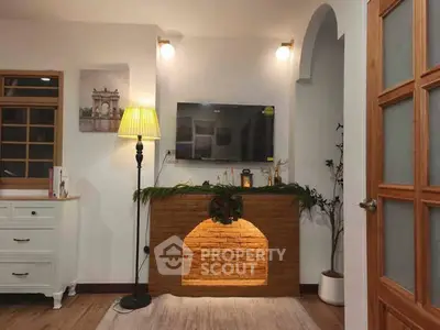 Charming living room with cozy decor and modern TV setup, perfect for relaxation and entertainment.