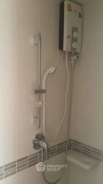 Modern bathroom shower with water heater and sleek tile design