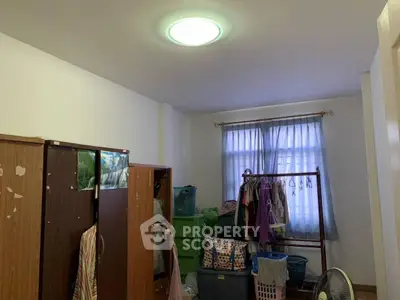 Cozy bedroom with wardrobe and natural light from window