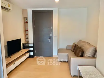Cozy living room with modern furniture and entertainment setup in a stylish apartment.