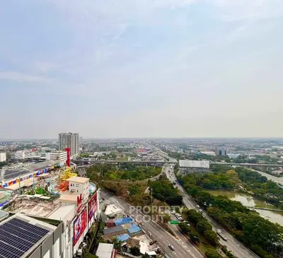 Stunning aerial view of urban landscape with roads, buildings, and lush greenery, perfect for real estate investment.