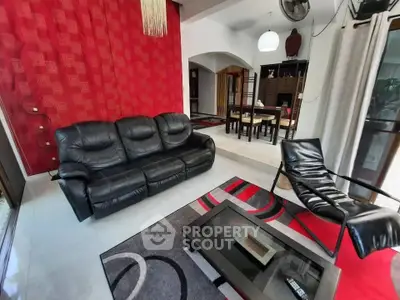 Stylish living room with modern furniture and vibrant red accent wall