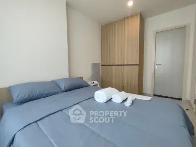 Modern bedroom with cozy bed and stylish wardrobe in a contemporary apartment.