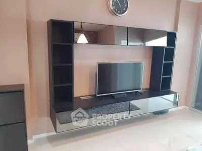 Modern living room with sleek TV unit and wall clock