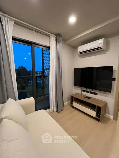 Modern living room with air conditioning and balcony view, perfect for cozy evenings.