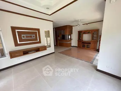 Spacious living room with elegant wooden furniture and tiled flooring