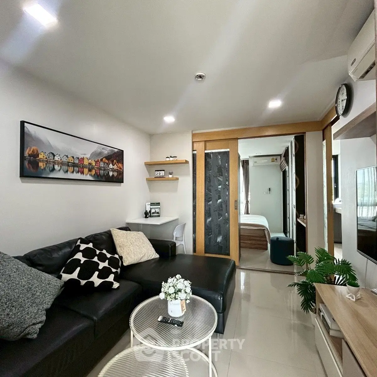 Modern living room with sleek black sofa and stylish decor