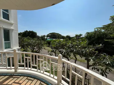 Charming balcony with lush garden view in serene residential area