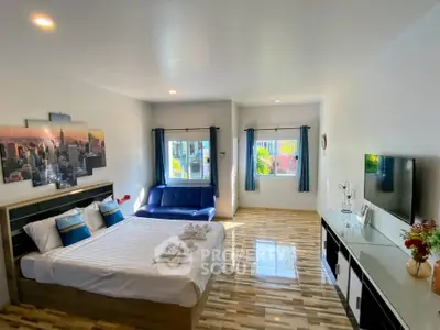 Spacious modern bedroom with stylish decor and natural light