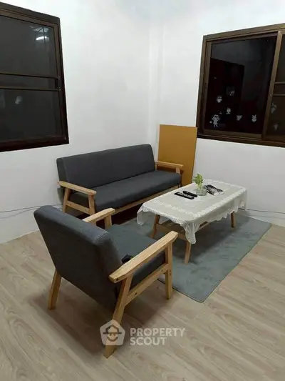 Cozy minimalist living room with modern furniture and natural light.