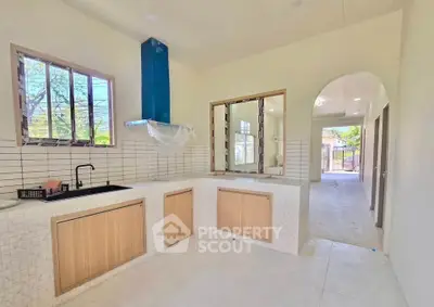 Spacious kitchen with modern design and open layout, featuring natural light and sleek finishes.
