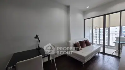 Modern living room with sleek furniture and balcony view in urban apartment