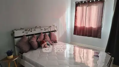 Cozy bedroom with natural light, modern decor, and comfortable bedding for a relaxing retreat.