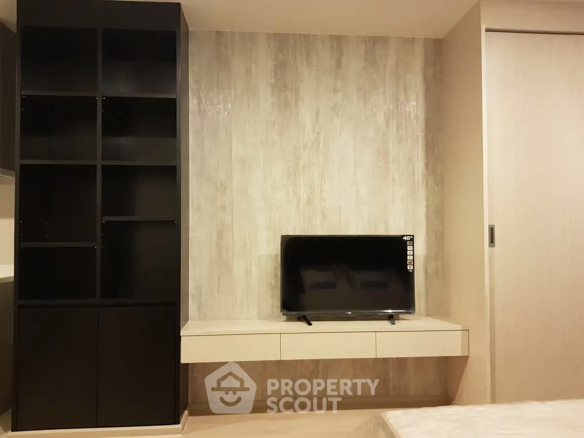 Modern living room with sleek TV setup and stylish shelving unit