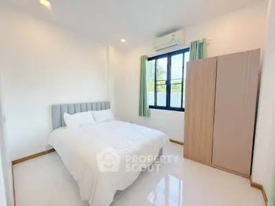 Bright and airy bedroom with modern furnishings and large window