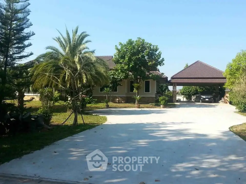 Charming suburban home with spacious driveway and lush greenery, perfect for serene living.