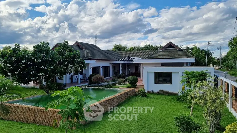 Stunning single-story home with lush garden and serene pond view