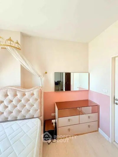 Charming bedroom with elegant tufted headboard and stylish dresser in a cozy apartment.