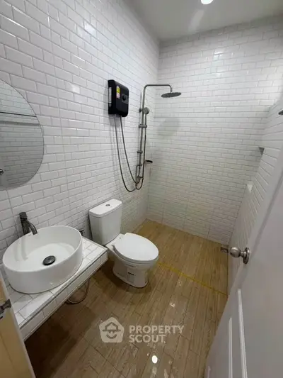 Modern bathroom with white subway tiles and sleek fixtures