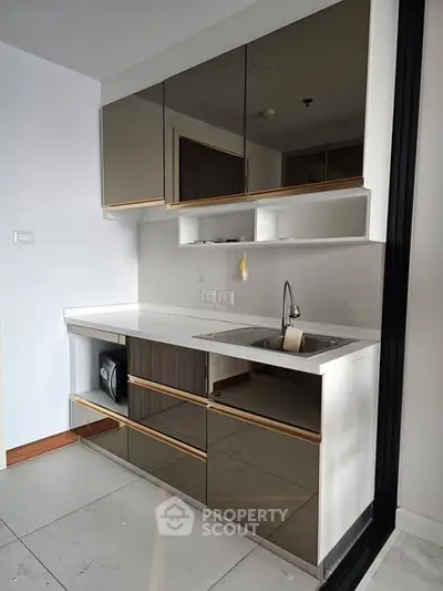 Modern kitchen with sleek cabinetry and built-in appliances in a contemporary apartment.