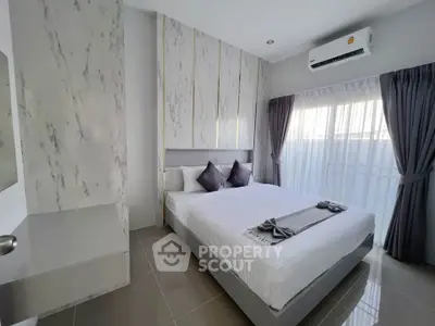 Modern bedroom with elegant decor and natural light, featuring a comfortable bed and stylish curtains.