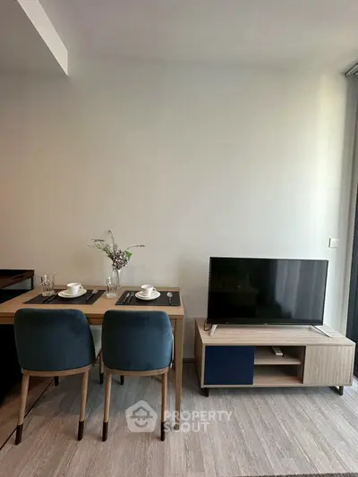 Modern living room with dining area and sleek TV setup