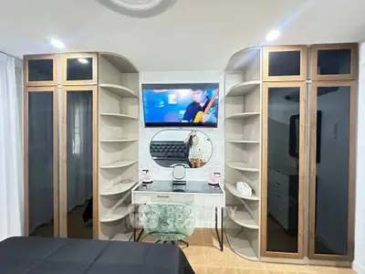 Stylish bedroom with modern vanity and built-in shelving