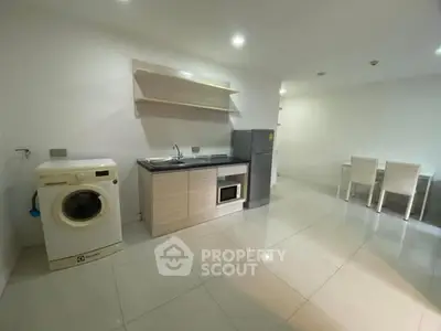 Modern minimalist kitchen with washing machine and dining area