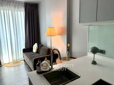 Modern living room with cozy sofa and stylish kitchen area