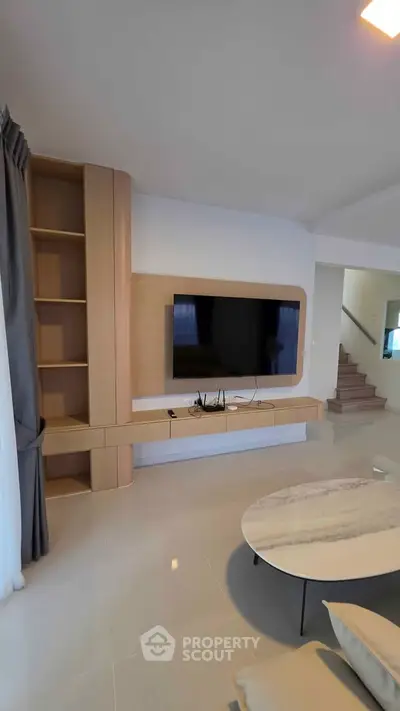 Modern living room with sleek TV setup and stylish shelving, perfect for contemporary living.