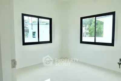 Bright empty room with large windows and glossy white floor tiles.